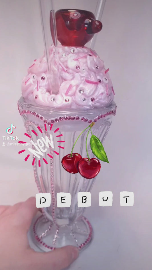 Strawberry milkshake with glass cherry